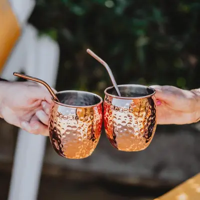 a person holding two glasses in their hands at Casa Marana by Le Lido in Lucciana