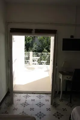 a door leading into a room with a patio at 1er Consul SAS a Bussinca in Bocognano