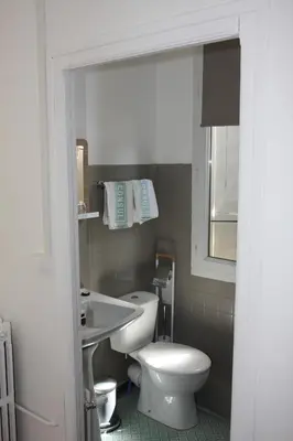 a bathroom with a white toilet and a sink at 1er Consul SAS a Bussinca in Bocognano