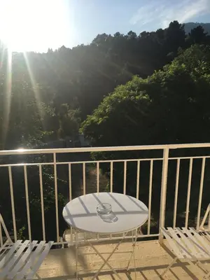 a surfboard sitting on a chair on a balcony at 1er Consul SAS a Bussinca in Bocognano
