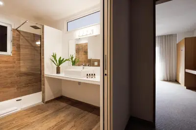 a bathroom with a sink and a mirror at Le Balamina in Porto-Vecchio