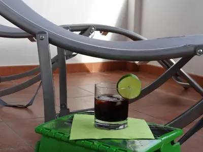 a drink with a lime on top of a chair at Vue sur mer et montagnes in Moriani Plage