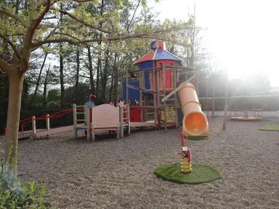 a playground with a slide in a park at Vue sur mer et montagnes in Moriani Plage