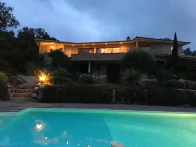 a house with a swimming pool in front of it at Domaine les Hauts de Capicciola in Pinarellu