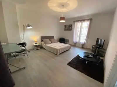 a bedroom with a bed and a table and a desk at Pascal Paoli in Corte