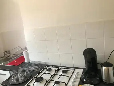 a kitchen counter with a stove top and a sink at Pascal Paoli in Corte