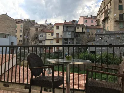 a table and two chairs on a balcony with a view at Pascal Paoli in Corte