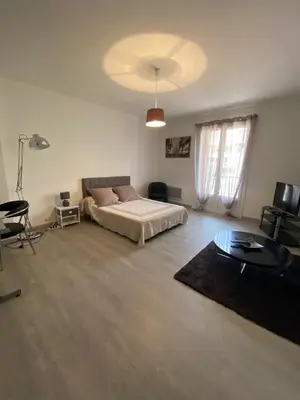 a large bedroom with a bed and a table at Pascal Paoli in Corte