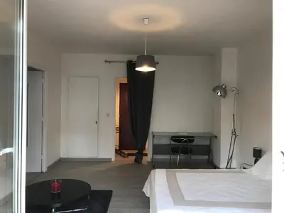 a bedroom with a bed and a table and a lamp at Pascal Paoli in Corte