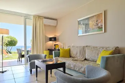 a living room with a couch and a table at Hôtel Restaurant Dolce Vita in Ajaccio