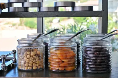 a group of jars of food on a table at Hôtel Restaurant Dolce Vita in Ajaccio