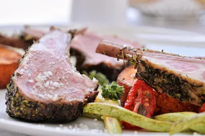 a plate of food with meat and vegetables on it at Hôtel Restaurant Dolce Vita in Ajaccio