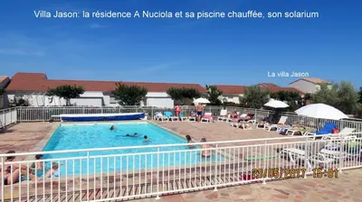 a swimming pool at a hotel with people in it at Jason in Cervione
