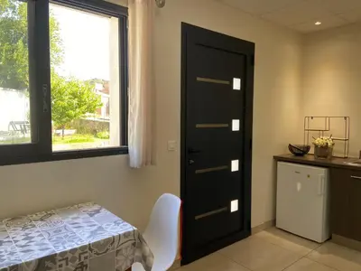 a dining room with a table and a black door at Casa Inde Noi in Corte
