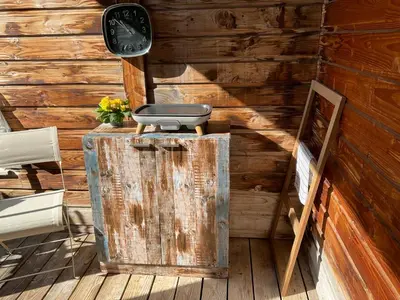 a room with a clock and a suitcase on top of a chest at Residence Cala Sultana -Baie Santa Giulia - rez jardin 1ere ligne in Porto-Vecchio