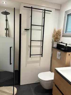 a bathroom with a toilet and a glass shower door at Residence Cala Sultana -Baie Santa Giulia - rez jardin 1ere ligne in Porto-Vecchio