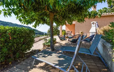 a group of chairs sitting on a patio under a tree at Nice Home In Casalabriva With Wifi in Casalabriva