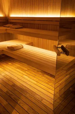 a sauna with two beds on a wooden floor at Grand Hôtel De Cala Rossa & Spa Nucca in Porto-Vecchio