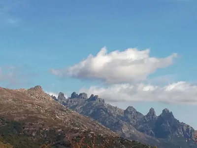 a view of a mountain range with a cloudy sky at Belvedere de Sartène in Sartène