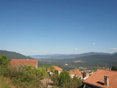 a view of a town with mountains in the distance at Belvedere de Sartène in Sartène