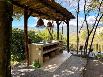 a garden with chairs and a table and a bench at Housica & Co. in Ucciani