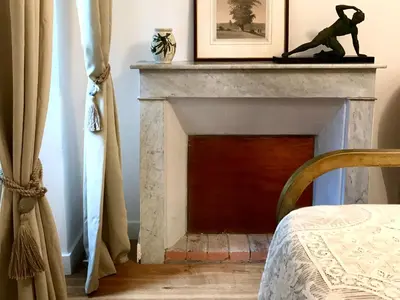 a floral dress with a pillow sitting on a chair at Housica & Co. in Ucciani