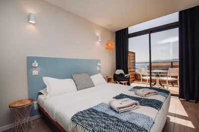 a bedroom with a bed with towels on it at Auberge Kallisté - Eco Label in Porto Pollo