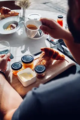 a person sitting at a table with a plate of food at Auberge Kallisté - Eco Label in Porto Pollo