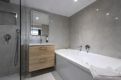 a bathroom with a tub and a sink and a shower at Auberge Kallisté - Eco Label in Porto Pollo