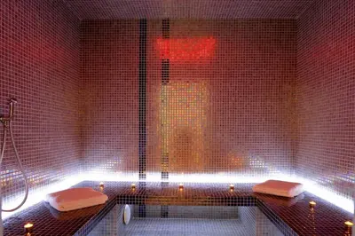 a bathroom with a shower and a tub with two towels at Les Roches Blanches in Porto-Vecchio