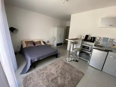 a small bedroom with a bed and a kitchen at Panate in Corte