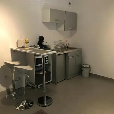 a kitchen with a sink and a counter with stools at Panate in Corte