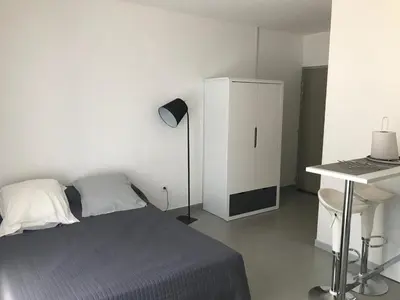 a bedroom with a bed and a desk and a white cabinet at Panate in Corte