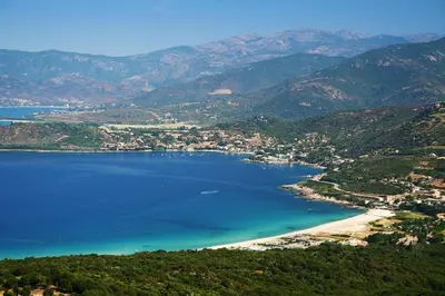 an aerial view of a beach with mountains at Residence Sejoina in Calcatoggio