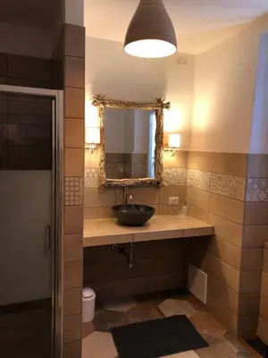 a bathroom with a sink and a mirror at Hotel La Terrasse in Zonza