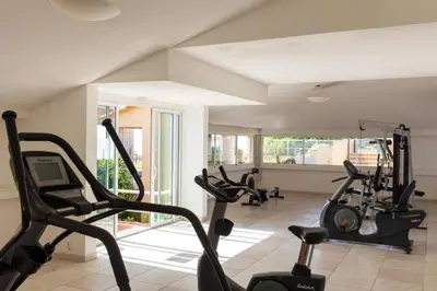 a gym with treadmills and ellipticals in a room at Résidence Marina Bianca in Santa-Lucia-di-Moriani