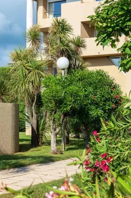 a street light in front of a building with trees at Résidence Marina Bianca in Santa-Lucia-di-Moriani