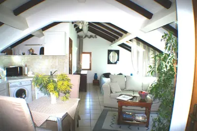 a living room with a couch and a table at Studio Le Petit Nid d'Amour meublé Tourisme 3 étoiles Poggio in Santa-Lucia-di-Tallano