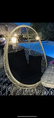 a wicker chair with two pillows sitting in it at Residence Paradisu Ajaccio in Appietto