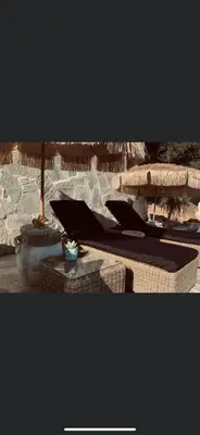 a group of chairs and umbrellas on a beach at Residence Paradisu Ajaccio in Appietto