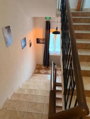 a staircase in a house with a stair case at Hôtel - Pub Le Petit Bosquet in Santo-Pietro-di-Venaco