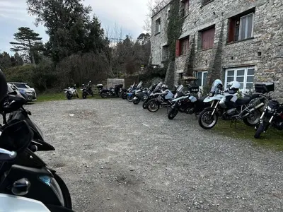 a row of motorcycles parked next to a building at Hôtel - Pub Le Petit Bosquet in Santo-Pietro-di-Venaco