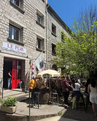 a group of people standing outside of a building at Hôtel - Pub Le Petit Bosquet in Santo-Pietro-di-Venaco