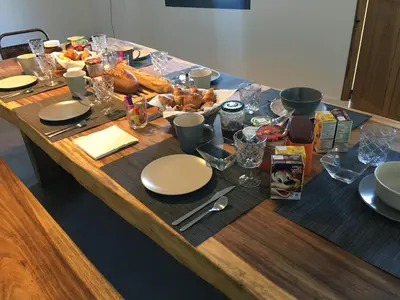 a wooden table with plates of food on it at Casa Santa Lucia in Bocognano