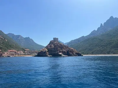 a small island in the middle of a body of water at Logis Hotel Le Lonca in Porto Ota