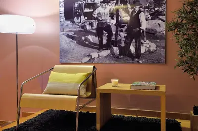 a living room with a couch and a table at Logis Hotel Le Lonca in Porto Ota