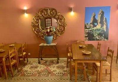 a dining room with a mirror and wooden tables at Logis Hotel Le Lonca in Porto Ota