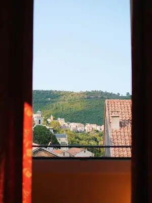 a view of a city from a window at Hôtel U Palazzu & Spa in Venaco