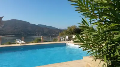 a swimming pool with a view of a mountain at Les Sables Blancs de la Liscia in Calcatoggio