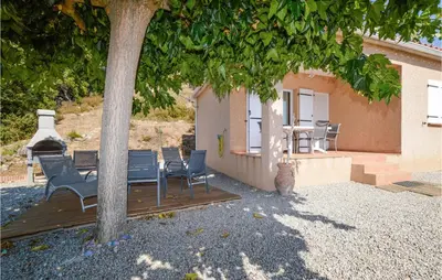 a cat sitting on a deck under a tree at Beautiful Home In Casalabriva With Wifi in Casalabriva